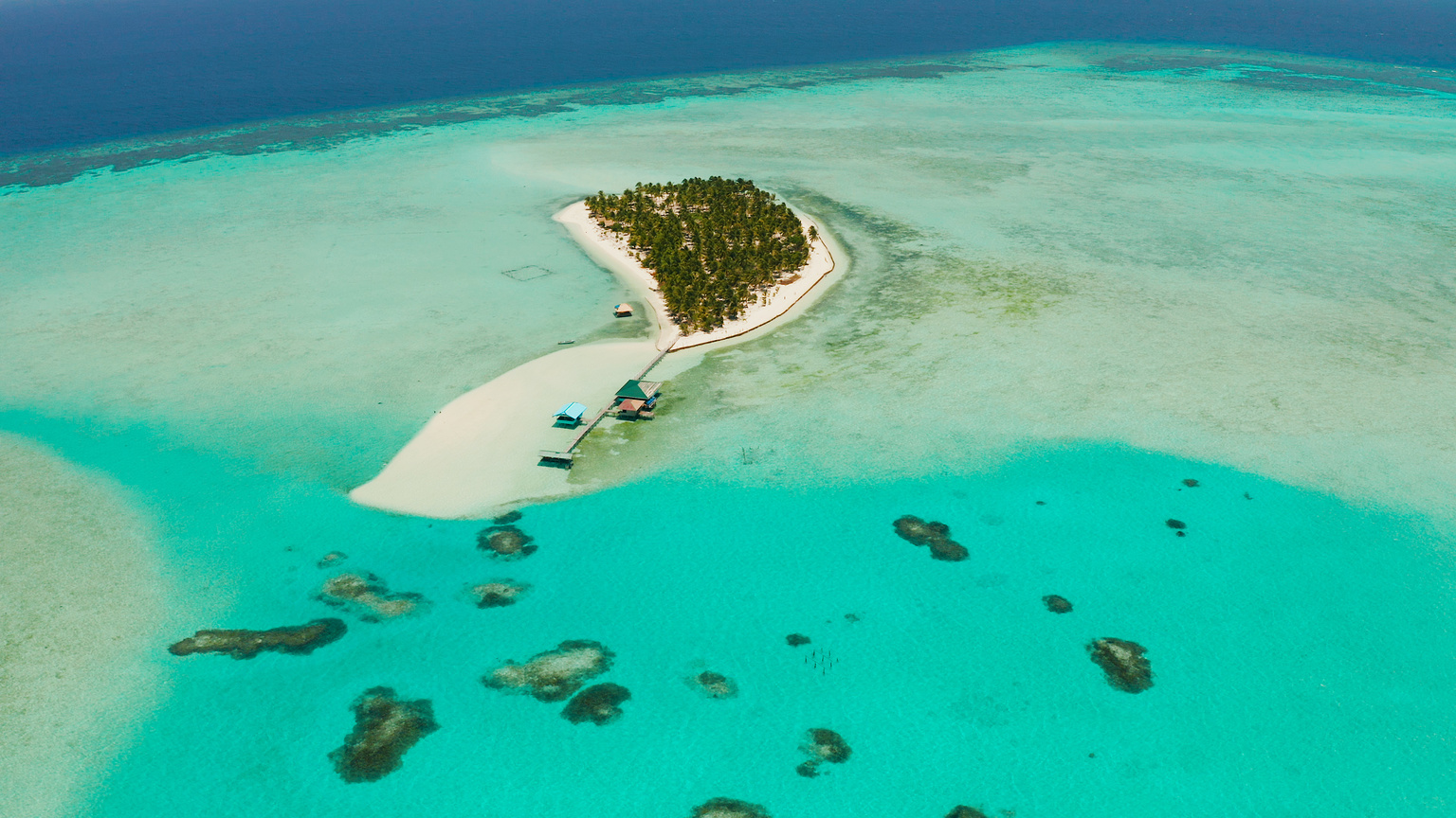 Tropical island with a beach on the atoll. Onok Island Balabac, Philippines.