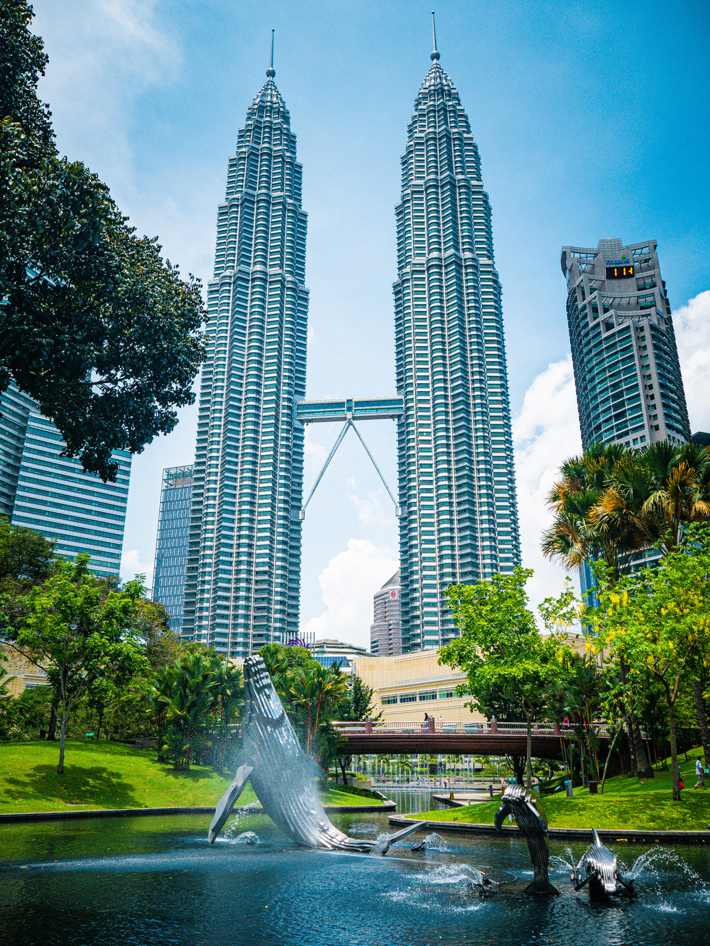 A Low Angle Shot of Petronas Twin Towers Under the Blue Sky and White Clouds